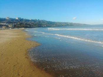 Scenic view of beach against clear sky