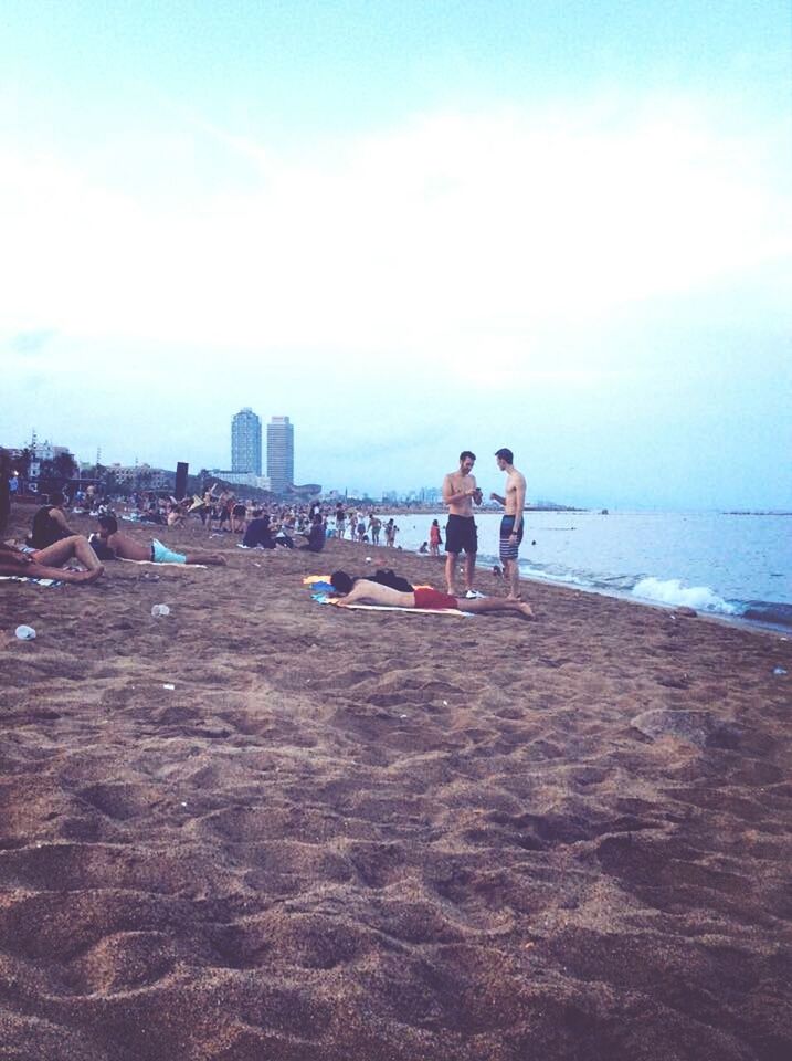 sea, water, beach, lifestyles, leisure activity, sky, togetherness, shore, sand, person, horizon over water, vacations, men, bonding, rear view, full length, childhood, boys