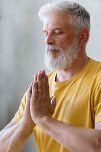 Mature man meditation at home