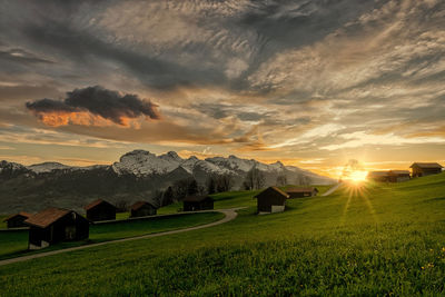 Scenic view of field against sky during sunset