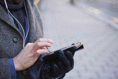 Close-up of man using smart phone