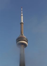 Low angle view of communications tower against sky