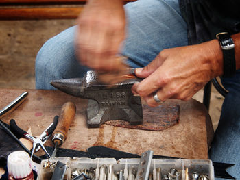 Midsection of male worker working at workshop