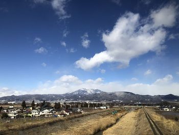 Panoramic view of landscape against blue sky