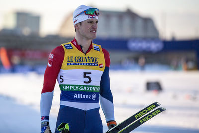Young man standing against blurred background