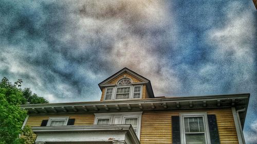 Low angle view of building against cloudy sky