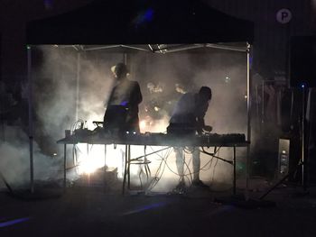 People enjoying music concert at night