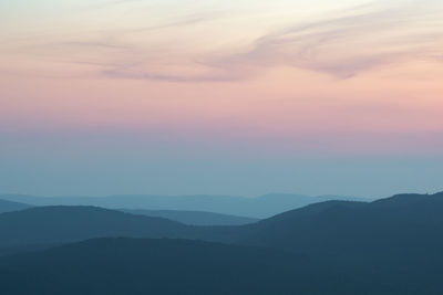 Scenic view of silhouette mountains against sky during sunset