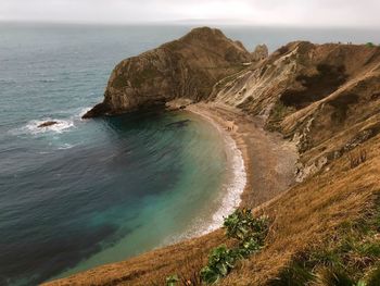 High angle view of rock formation in sea against sky