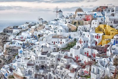 High angle view of townscape by sea against sky