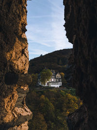 Rock formations by buildings against sky