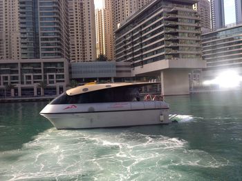 Boats in river with buildings in background