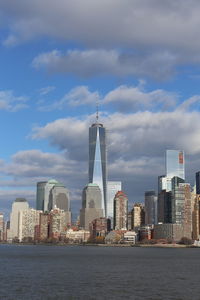 Modern buildings in city against cloudy sky