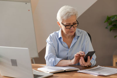 Female doctor working at table