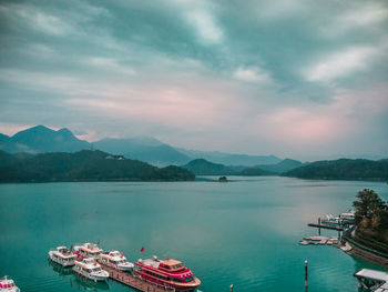 Scenic view of sea and mountains against sky
