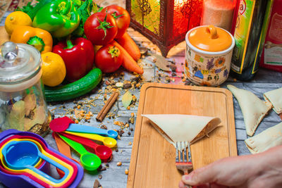 Cropped hand of person preparing food on table