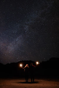 Couple under  milky way during wintertime. 