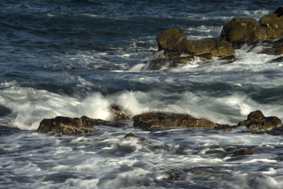 Sea waves splashing on rocks