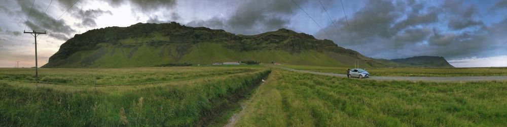 Panoramic view of agricultural field against sky