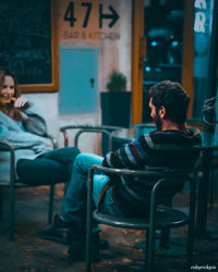 Rear view of couple sitting on chair