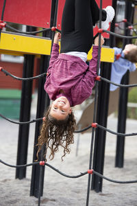 Girl playing on climbing frame