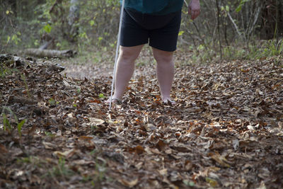 Low section of blind woman standing on field