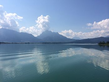 Scenic view of mountain range against cloudy sky