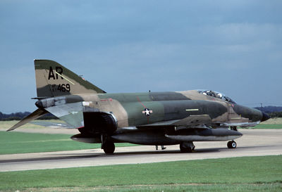 Side view of airplane at airport runway against sky