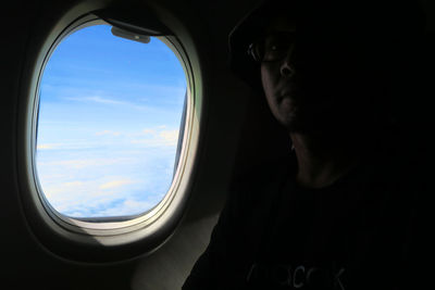 Low angle view of airplane seen through window