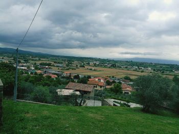 Houses on landscape against sky