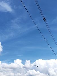 Low angle view of power lines against sky