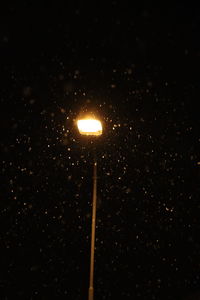 Low angle view of illuminated street light at night