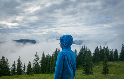 Side view of person standing in mountains