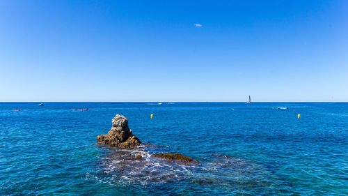 Scenic view of sea against clear blue sky