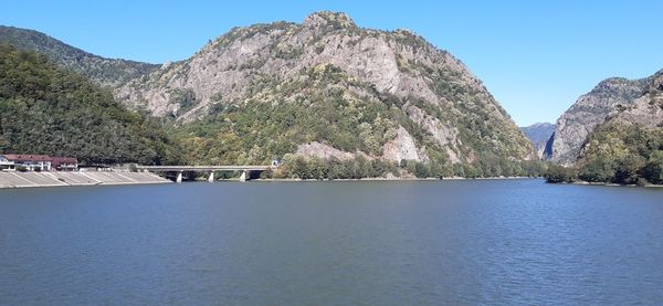 Scenic view of lake and mountains against sky