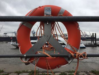 Close-up of red boat in sea against sky