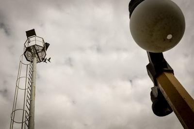 Low angle view of street light against cloudy sky