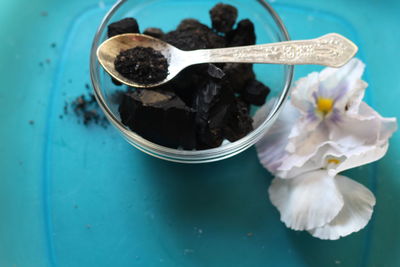 High angle view of flowers with coal on plate