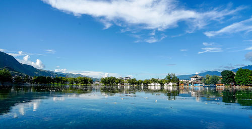 Scenic view of swimming pool by lake against sky