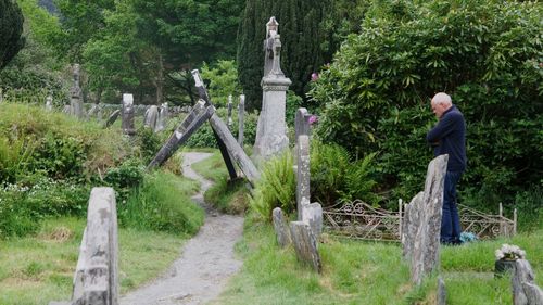 Man standing in cemetery