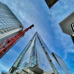 Low angle view of buildings against cloudy sky