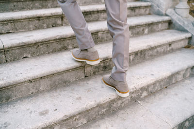 Low section of person standing on staircase