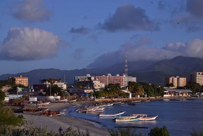 Panoramic view of town and mountains against sky