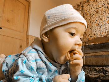 Close-up portrait of cute boy wearing hat