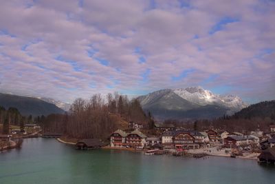 Scenic view of lake by buildings against sky