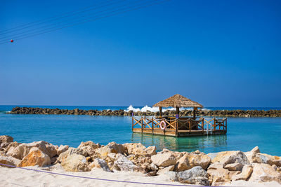 Scenic view of sea against clear blue sky