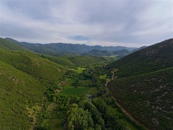 Scenic view of green landscape against sky