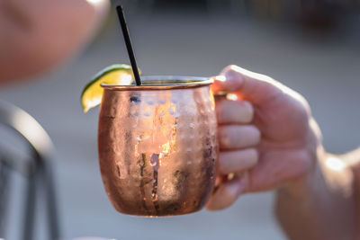 Close-up of hand holding drink