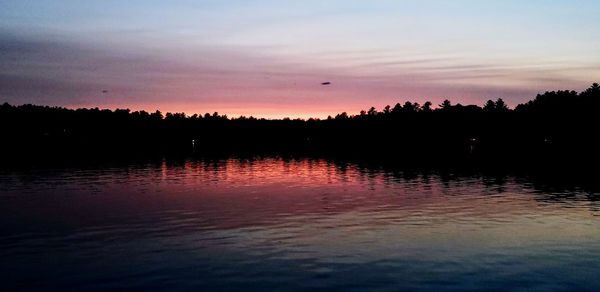 Scenic view of lake against romantic sky at sunset