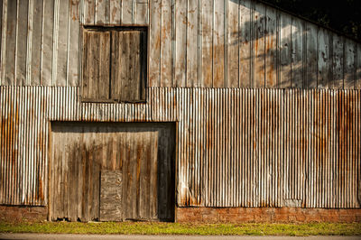 Old barn on field against wall